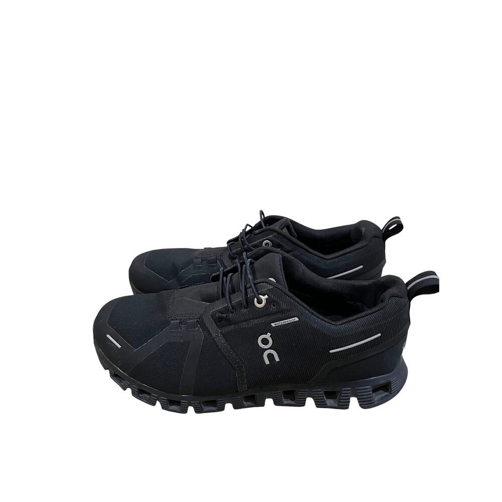 On Cloud waterproof running shoes for women in solid black. - Picture 2 of 9
